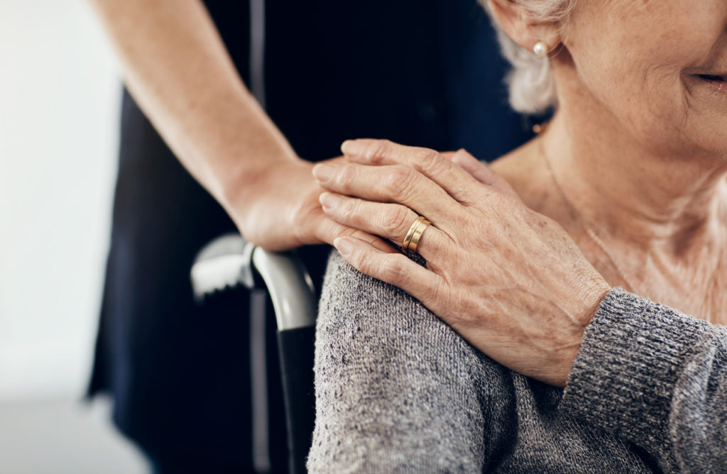 Cropped shot of a female caregiver comforting a senior woman